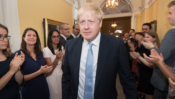 Boris Johnson is greeted by staff inside 10 Downing Street