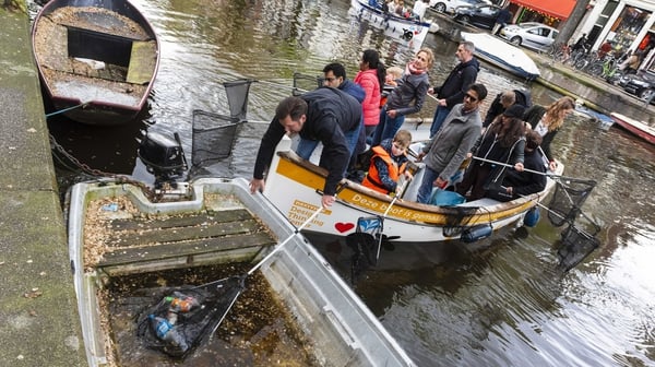 Volunteers fish the plastic out of the canals in Amsterdam