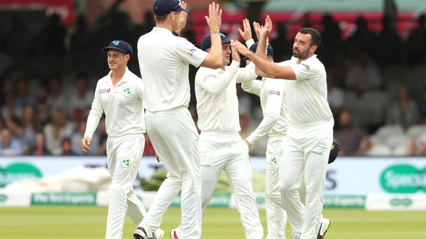 Ireland players celebrate the wicket of England's Oliver Stone