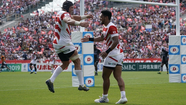 Timothy Lafaele of Japan celebrates his try with team mate Pieter Labuschagne