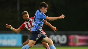 Liam Kerrigan of UCD is tackled by Darren Cole of Derry City