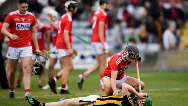 Evan Shefflin of Kilkenny is consoled by Cork's Simon Kennefick