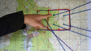 A Royal Malaysian Police officer points to a map showing the search and rescue operation area