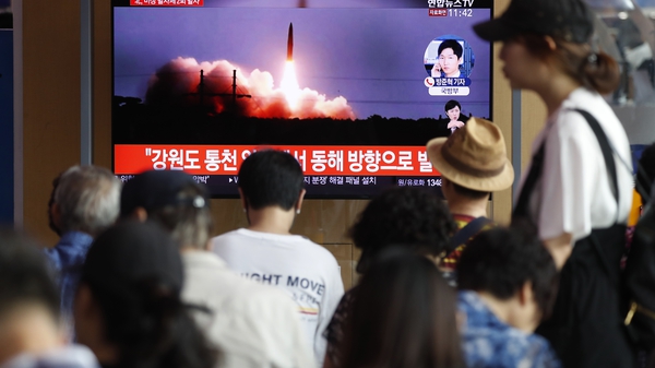 South Korean people watch a breaking news broadcast about North Korea's missile launch
