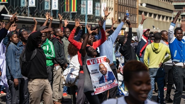 Scores of people gathered in the capital's Africa Unity Square to demonstrate against the country's worsening economy