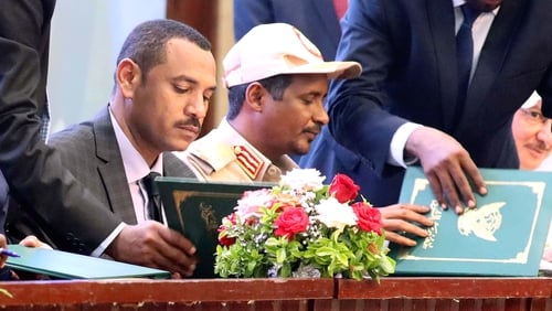 Ahmad al-Rabie and Mohamed Hamdan Dagalo sign the agreement in Khartoum