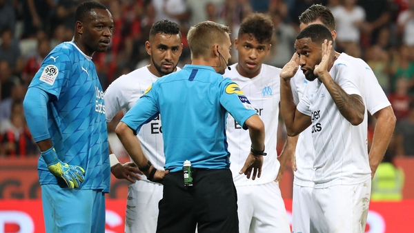Marseille defender Jordan Amavi (R) argues with the referee over the awarding of a penalty kick during the derby clash with Nice