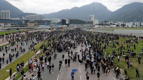 Protesters block a road leading to Hong Kong International Airport