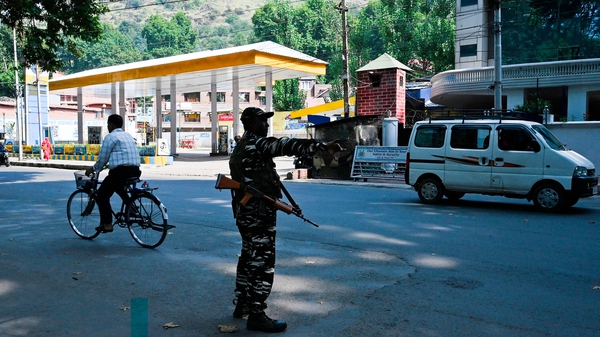 An Indian paramilitary soldier stands guard on a street during a lockdown in Srinagar