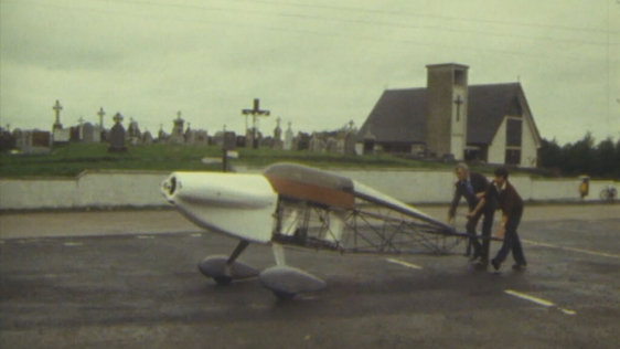 Padraig Forde and Donal Connaire wheel plane through Bullaun village, Co. Galway (1984)