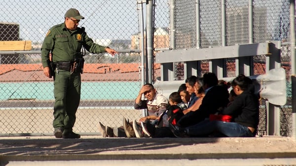 US authorities arrest migrants after crossing the Bravo river in Ciudad Juarez at the border between Mexico and USA