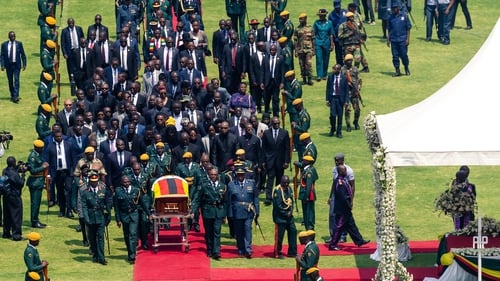 Officials accompany Robert Mugabe's coffin in Harare