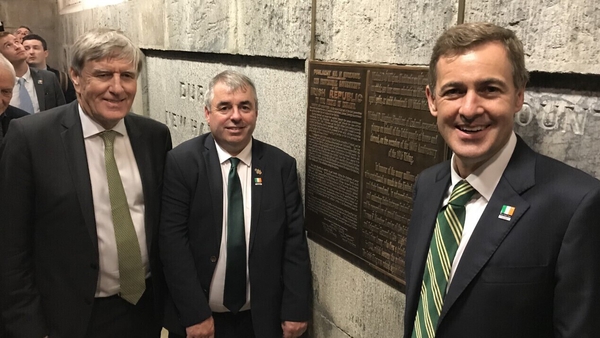 Irish Ambassador to the US Daniel Mulhall, Minister of State Kevin 'Boxer' Moran and Senator Mark Daly alongside the plaque at the Washington Monument