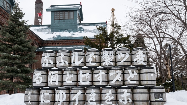 A stack of sake barrels in front of the Sapporo Beer Museum.