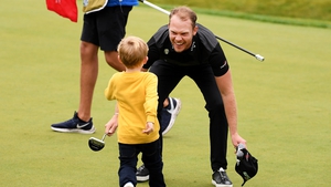Willett celebrates after the last with his son