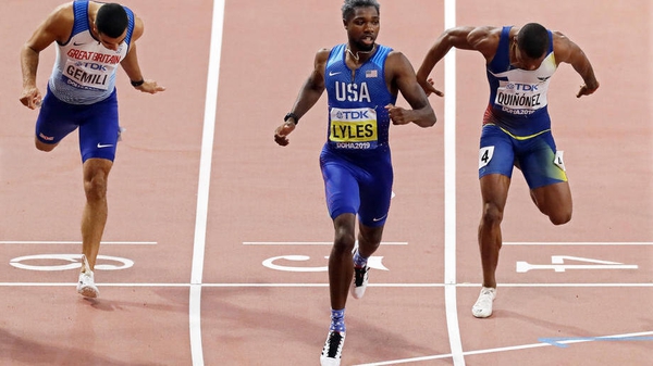 Noah Lyles (C) of the USA crosses the finish line to win the men's 200m final