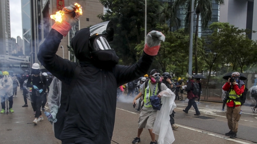 A protester throws a flaming projectile in the latest Hong Kong protests