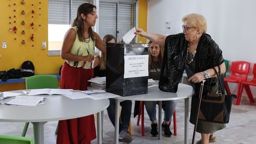 A woman casts her vote at a polling station near Lisbon