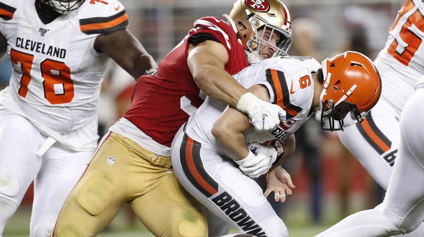San Francisco 49ers defensive end Nick Bosa (C) sacks Cleveland Browns quarterback Baker Mayfield (R)