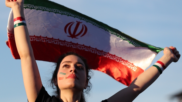 An Iranian woman watches her country play from a fan zone at the 2018 World Cup in Russia