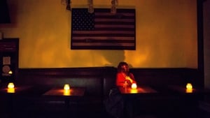 A local sits in a candle-lit restaurant in Sonoma, California, during the planned power outage