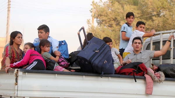 Kurdish families flee their home towns Ras al Ain as Turkish troops advance