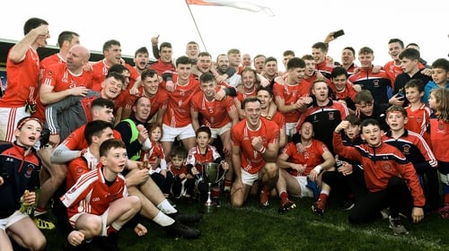 Padraig Pearses players and supporters celebrate with the Fahey Cup