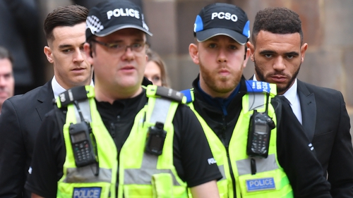 Police escort Derby County footballers Tom Lawrence (rear left) and Mason Bennett (rear right) from Derby Magistrates' Court