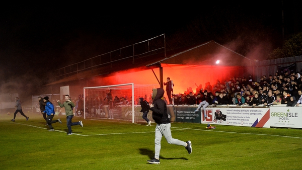 Bohemians fans pour onto the pitch at full-time