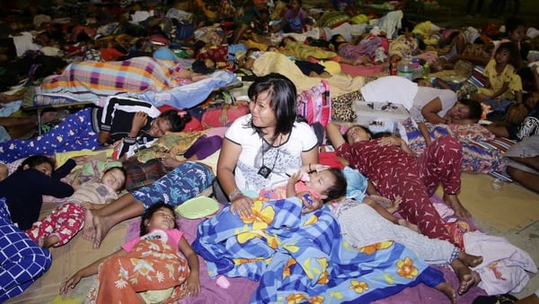 Villagers take shelter in a temporary evacuation centre in Digos City