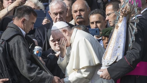 Pope Francis kisses the Falkland (Malvinas) unknown soldier's marble stele during his weekly general audience in St Peter's Square today
