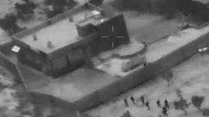 The grainy image shows troops advancing on the compound of IS leader Abu Bakr al-Baghdadi
