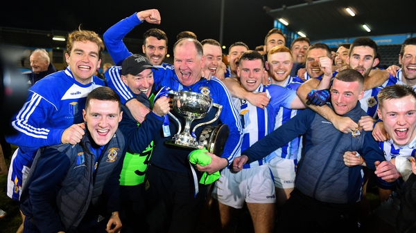Ballyboden St Enda's players and officials celebrate with the cup