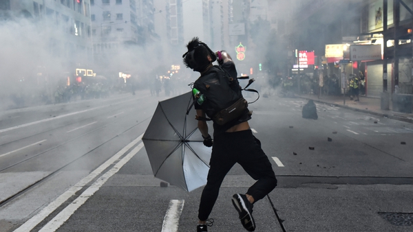 A protester in action after the police fired tear gas during a pro-democracy rally in Hong Kong