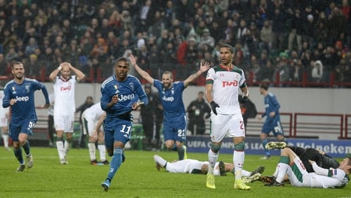 Douglas Costa wheels away in celebration after his late winner for Juventus against Lokomotiv Moscow