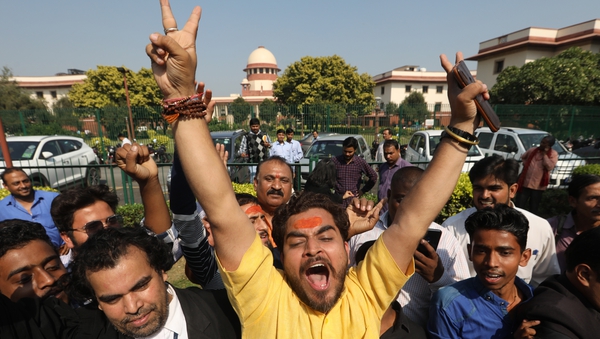 A Hindu devotee reacts after the announcement of the verdict