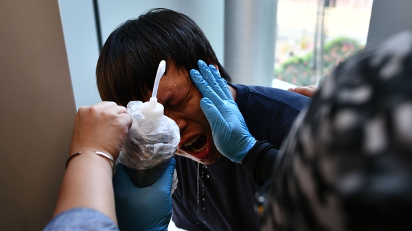 A protester affected by tear gas is attended to