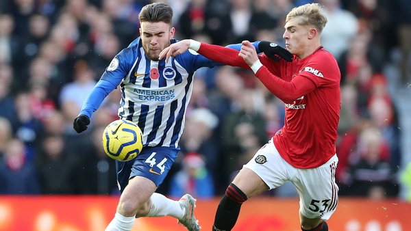 Aaron Connolly battles for possession with Manchester United's Brandon Williams