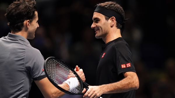 Dominic Thiem is congratulated by Roger Federer at the O2