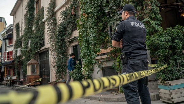 A Turkish police officer stands guard outside the home and office of James Le Mesurier in Istanbul