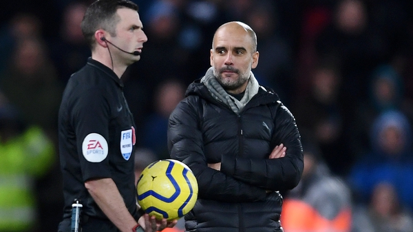 Pep Guardiola (R) with referee Michael Oliver
