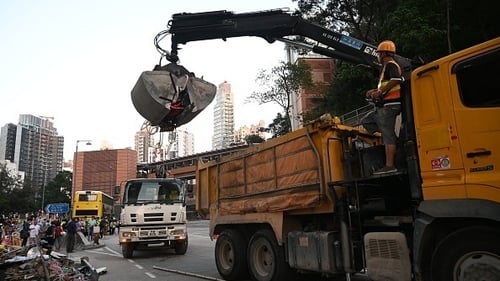 Government supporters began removing roadblocks put in place by pro-democracy protesters