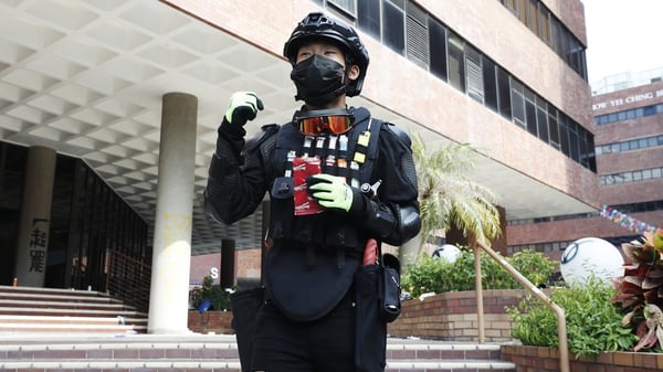 A protester is seen wearing a vest of fire lighters in Hong Kong Polytechnic University