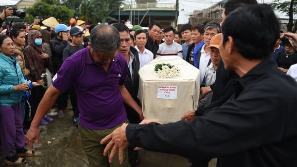 Relatives carry the remains of one of the victims after body was repatriated from Britain
