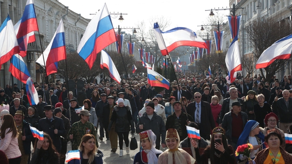 People carry Russian flags during celebrations of the fifth anniversary of Russia's annexation of Crimea in Simferopol earlier this year