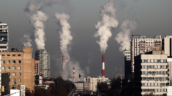 Smoke rises from the chimneys of a gas boiler house in Moscow