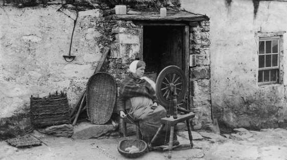 Woman spinning wool outside her cottage, Rosapenna, Co. Donegal (1880)