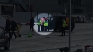 Lisa Smith, covered in a pink blanket, at Dublin Airport