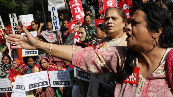 Indian activists hold placards and shout slogans as they protest in New Delhi, India