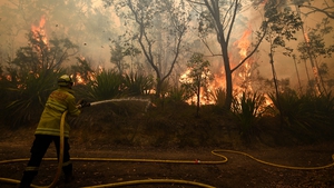 Fire crews work to protect properties as the fires intensify